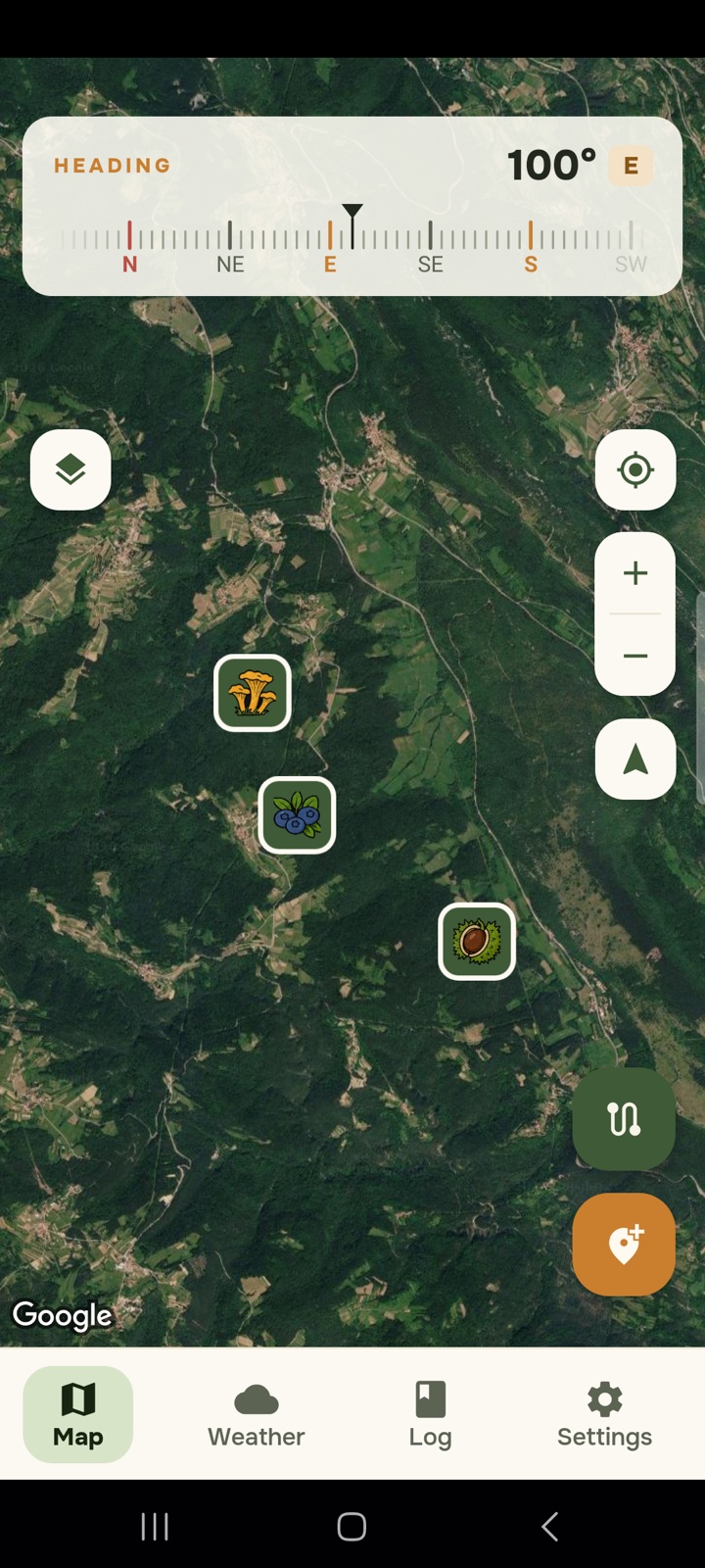 Satellite map with a heading compass at the top and three saved spots marked with chanterelle, blueberry and chestnut icons